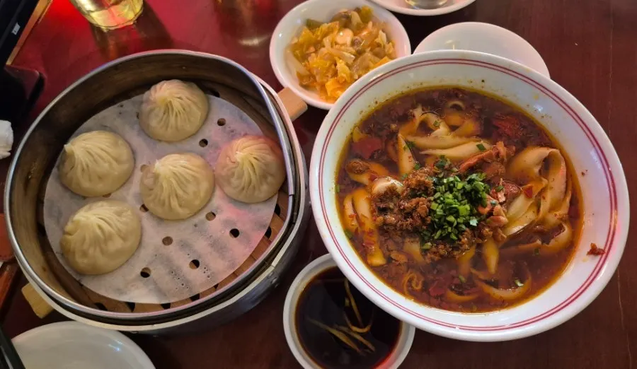 A bowl of Sichuan-style beef knife-cut noodles topped with chili oil