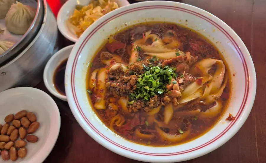 Beef knife-cut noodles topped with minced meat and chives