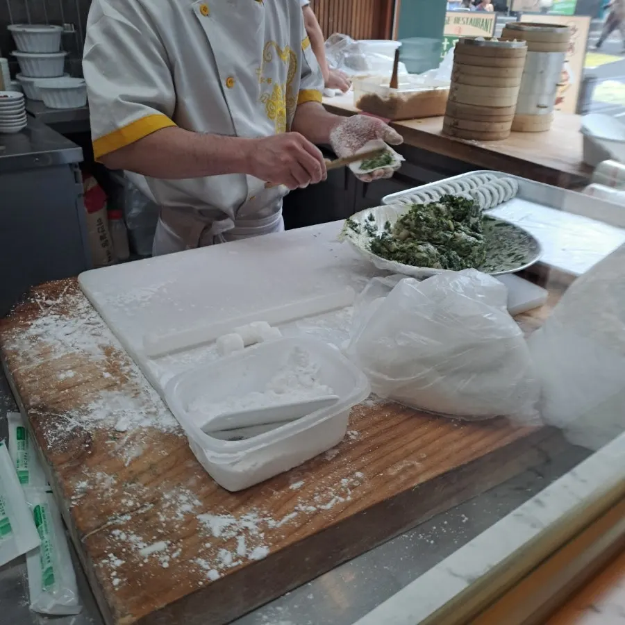 Table spread with dim sum and cooked dishes