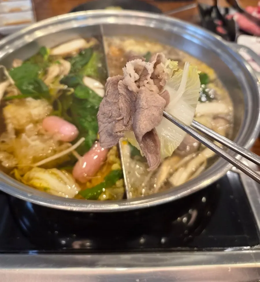 Vegetables and meat added to the half-and-half broth