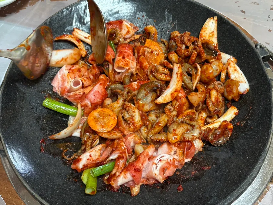 Jjuksam being stir-fried on the griddle