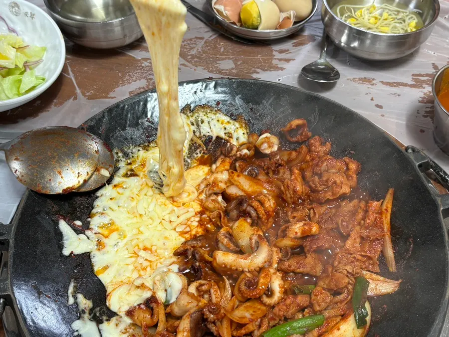 Cheese being melted on top of the jjuksam griddle