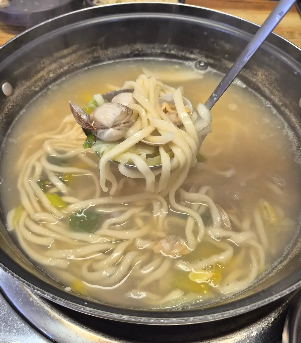 Clam kalguksu filled with scallops, surf clams, littleneck clams, and hard clams