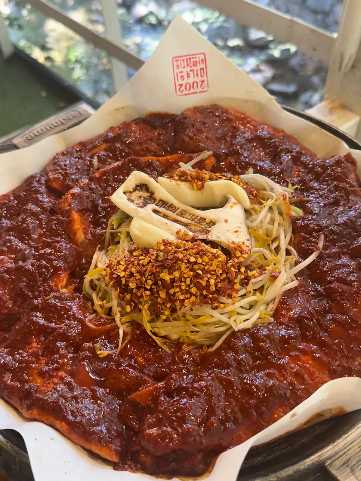 Three servings of tomato-jang pork belly on the table by the stream