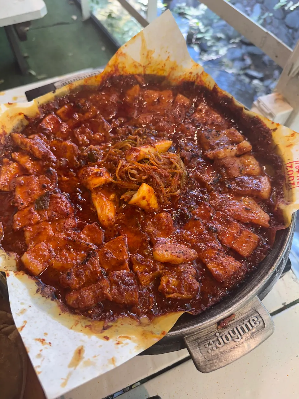 Tomato-jang pork belly finished with a torch for a smoky flavor