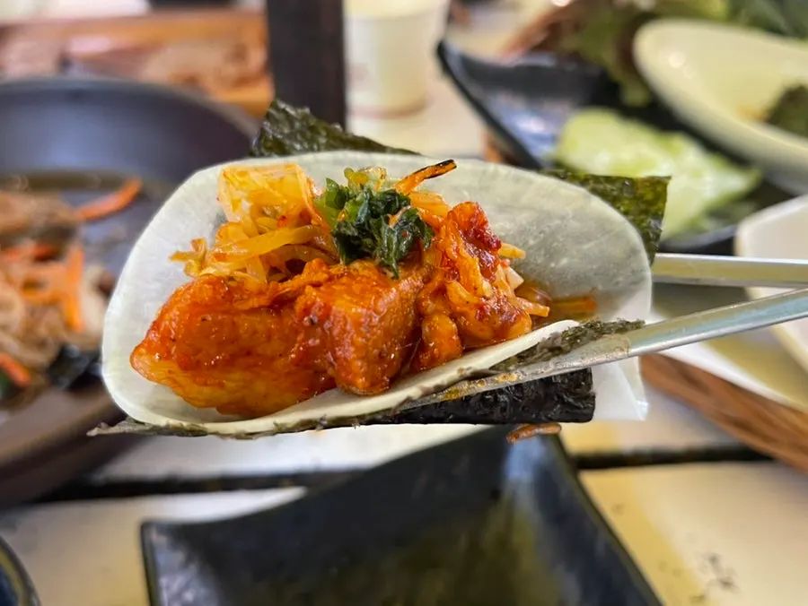 A wrap of meat and fixings in a rice cracker