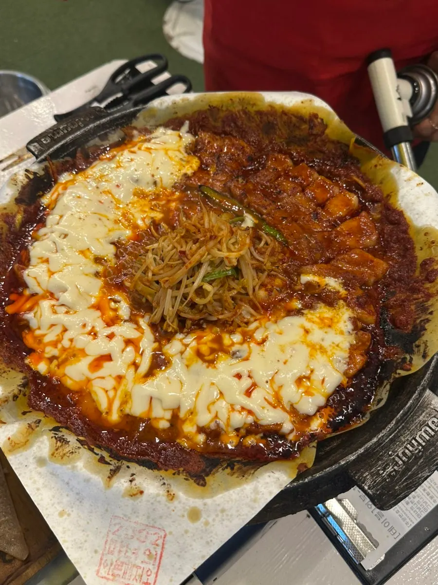 Close-up of melted cheese tomato-sauce pork belly