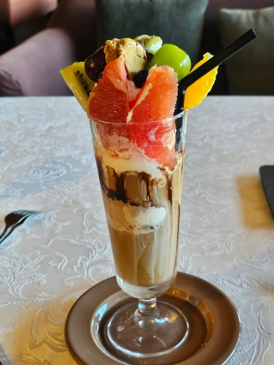 Honor & Chevalier topped with fruit and ice cream