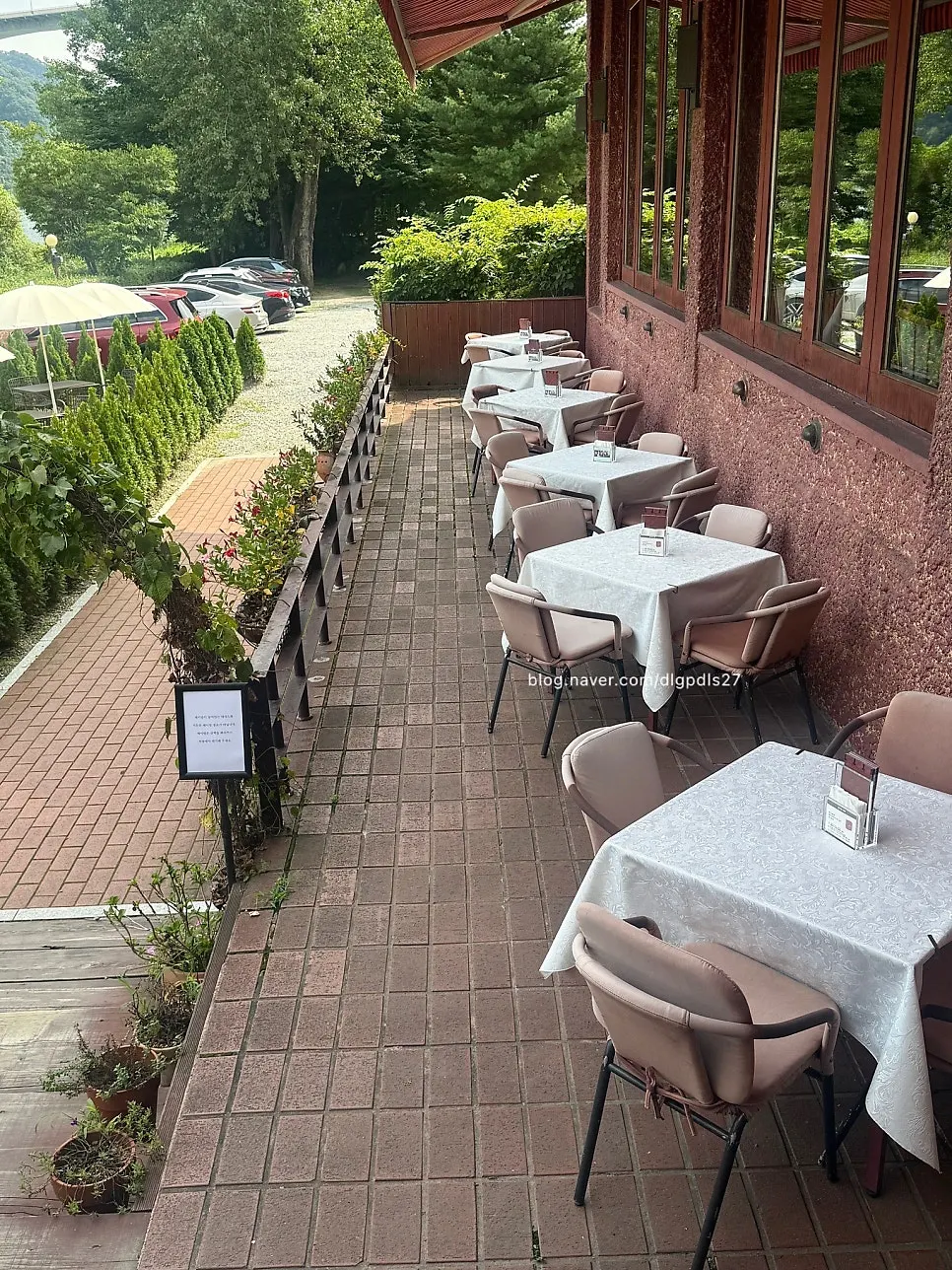 Outdoor seats with riverside trees in the background