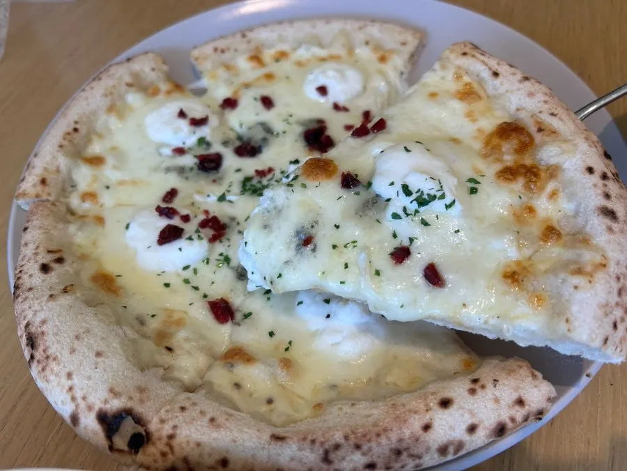 Pizza topped with several cheeses