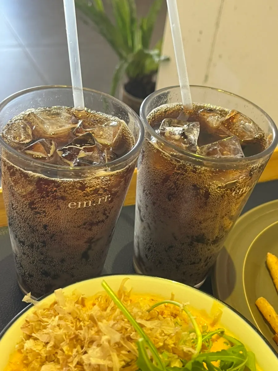 Cola served alongside burger and curry udon