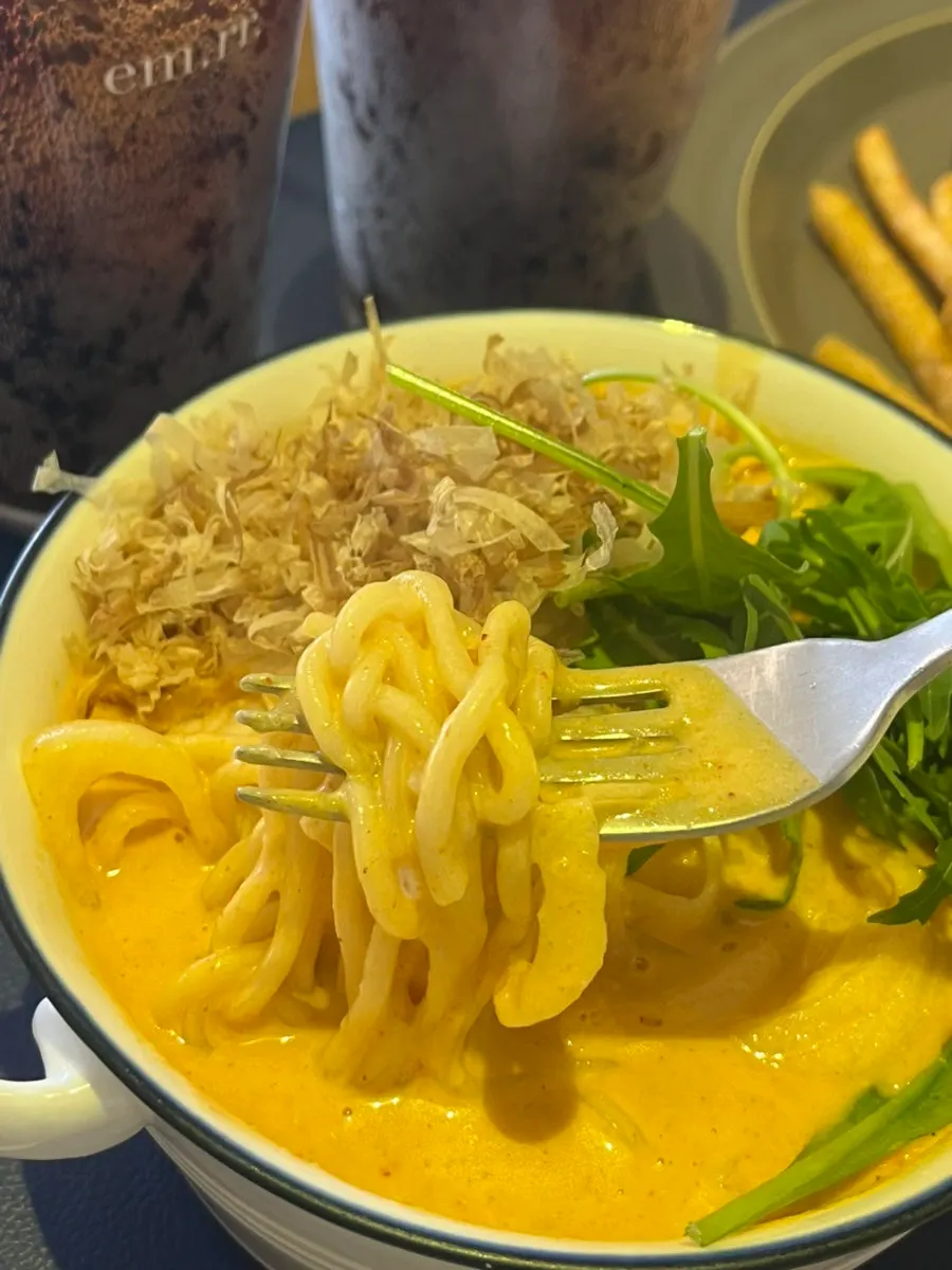 Udon noodles coated in cream curry sauce