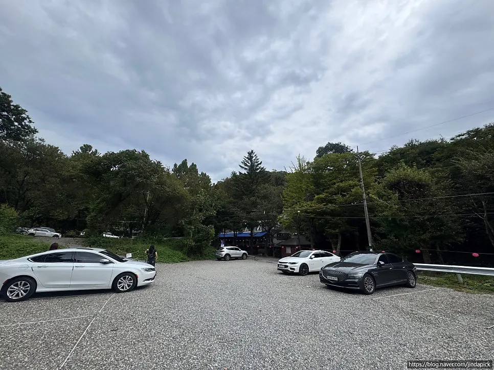 Wide gravel parking lot below the restaurant