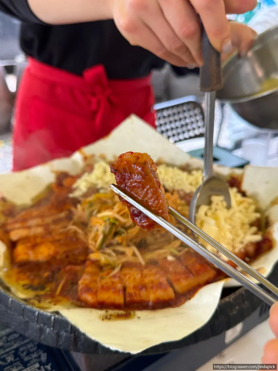 Tomato-jang pork belly cooking on the grill