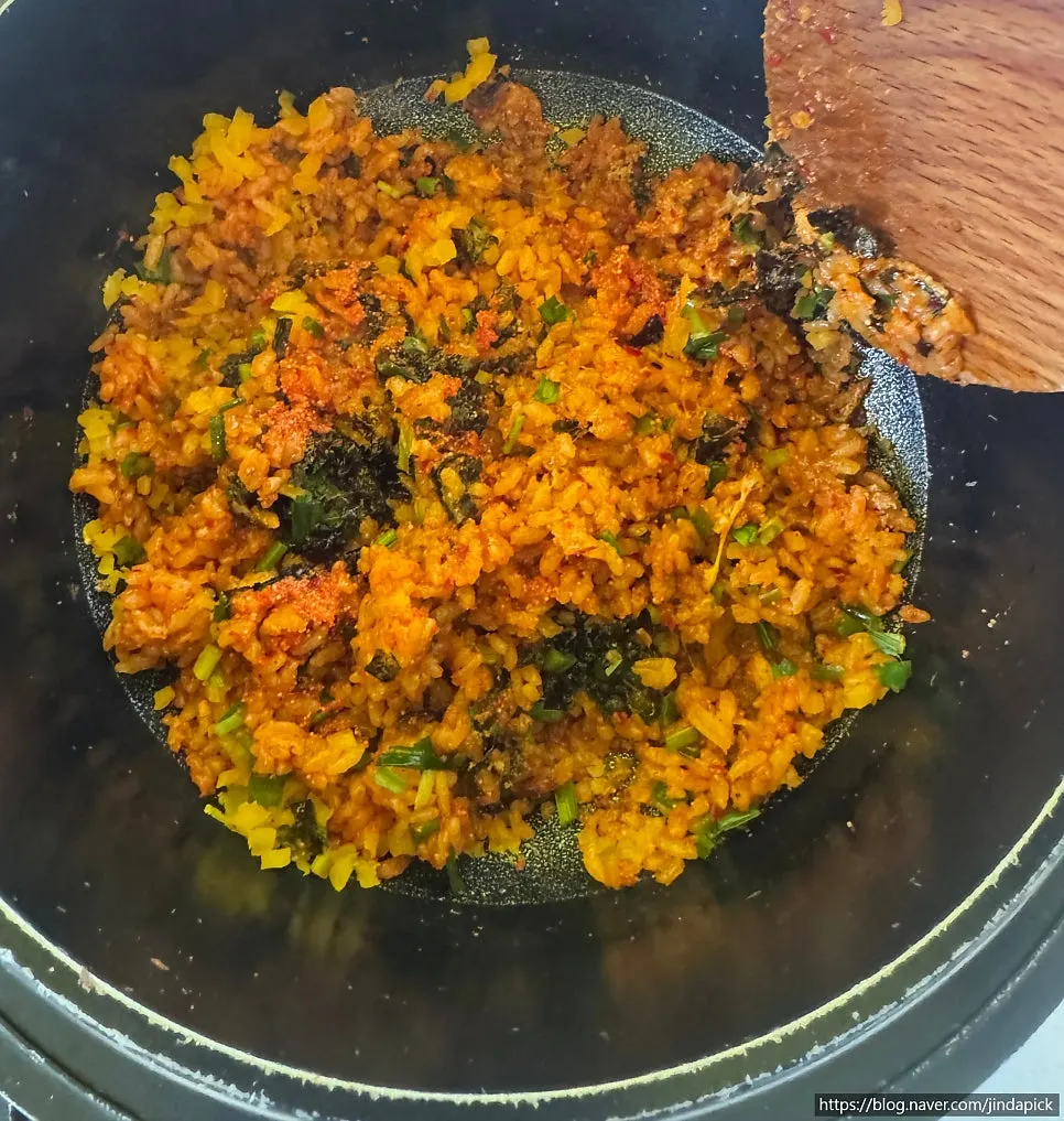 Scraping up the crisped nurungji fried rice