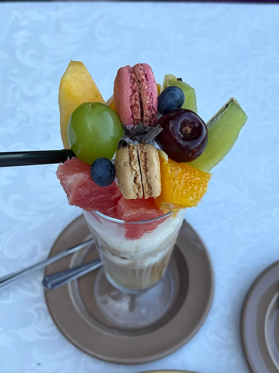Honoré en Chevalier topped with a macaron and seasonal fruit