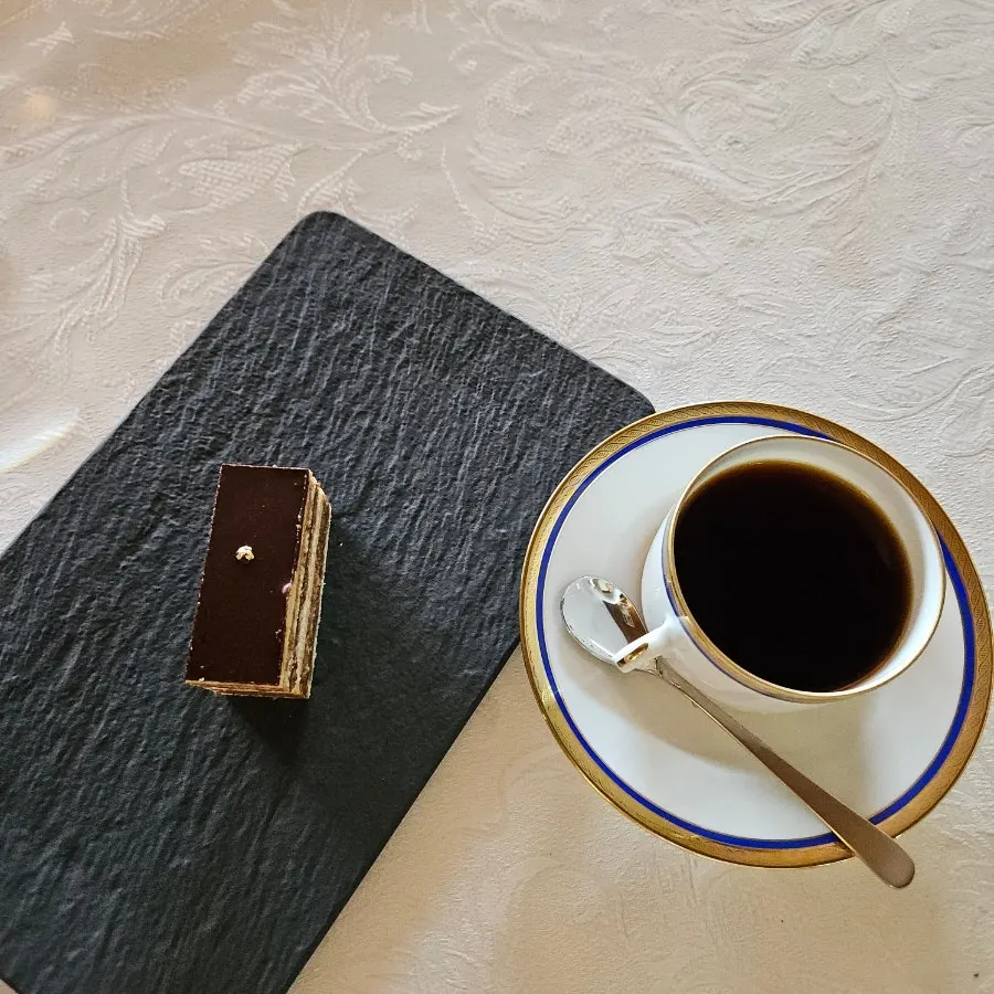 Opera cake enjoyed alongside coffee