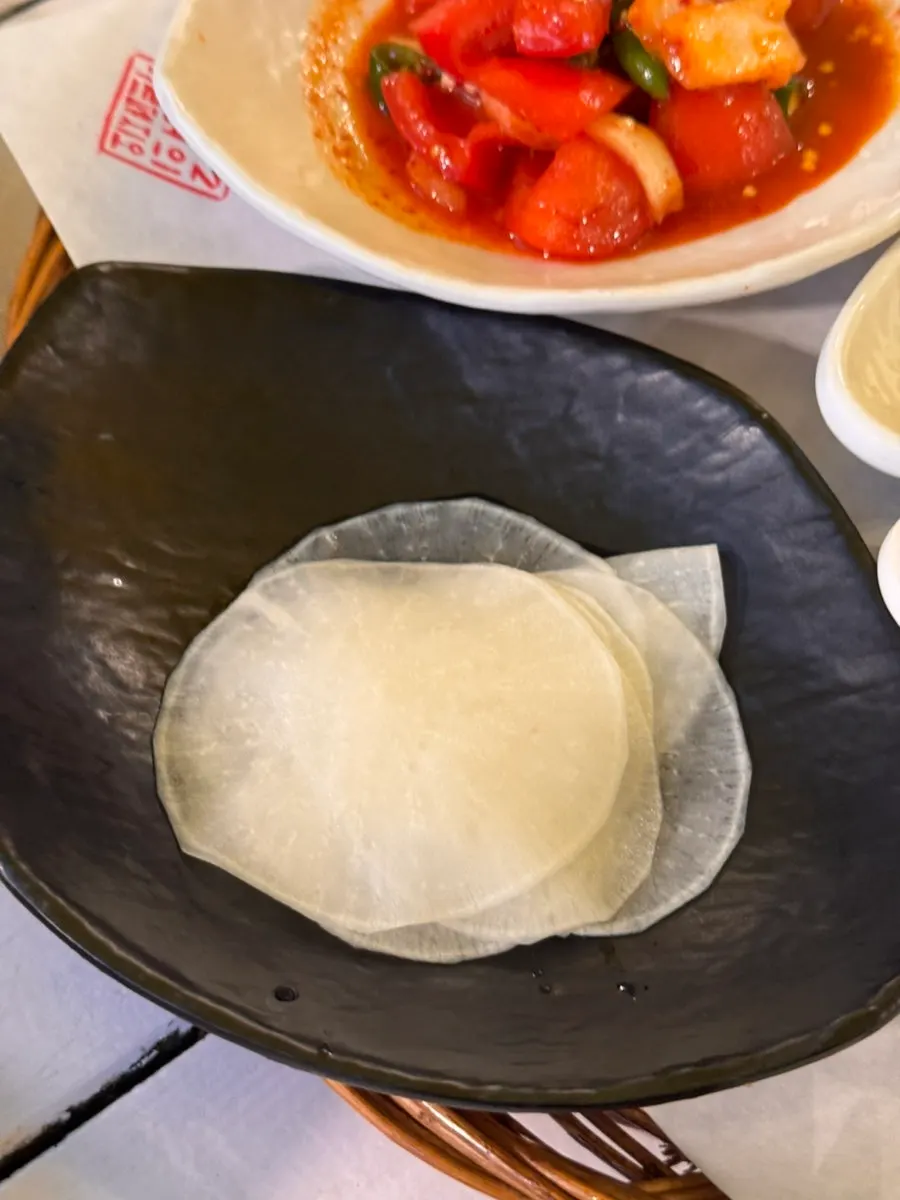 Tomato kimchi with pieces of tomato flesh visible