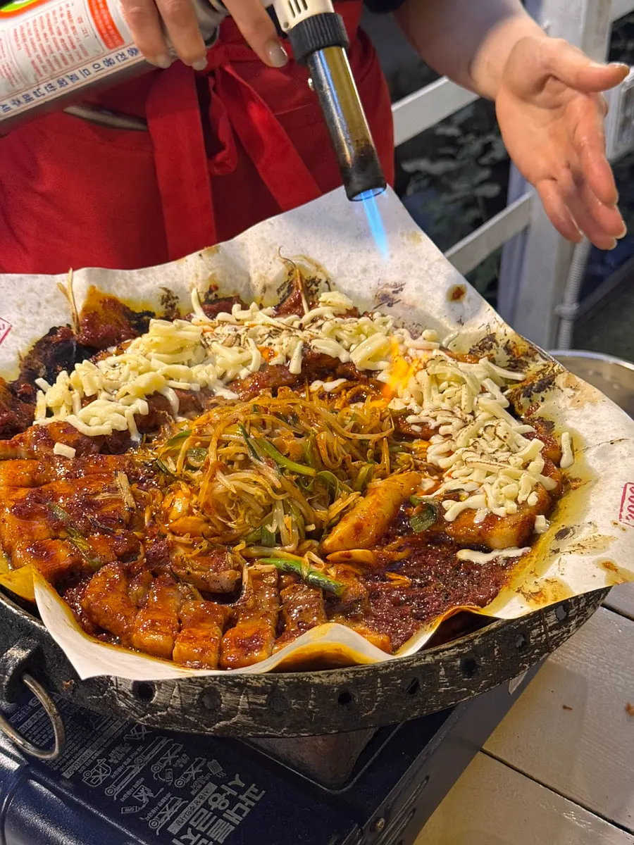 Cheese placed on just half of the pork belly