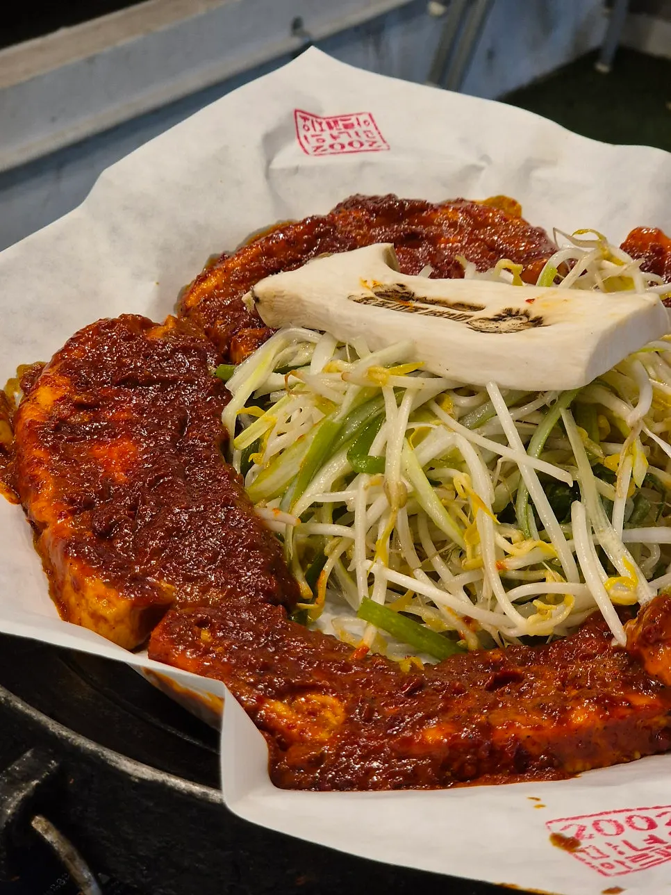 Thick pork belly slices topped with tomato-jang sauce