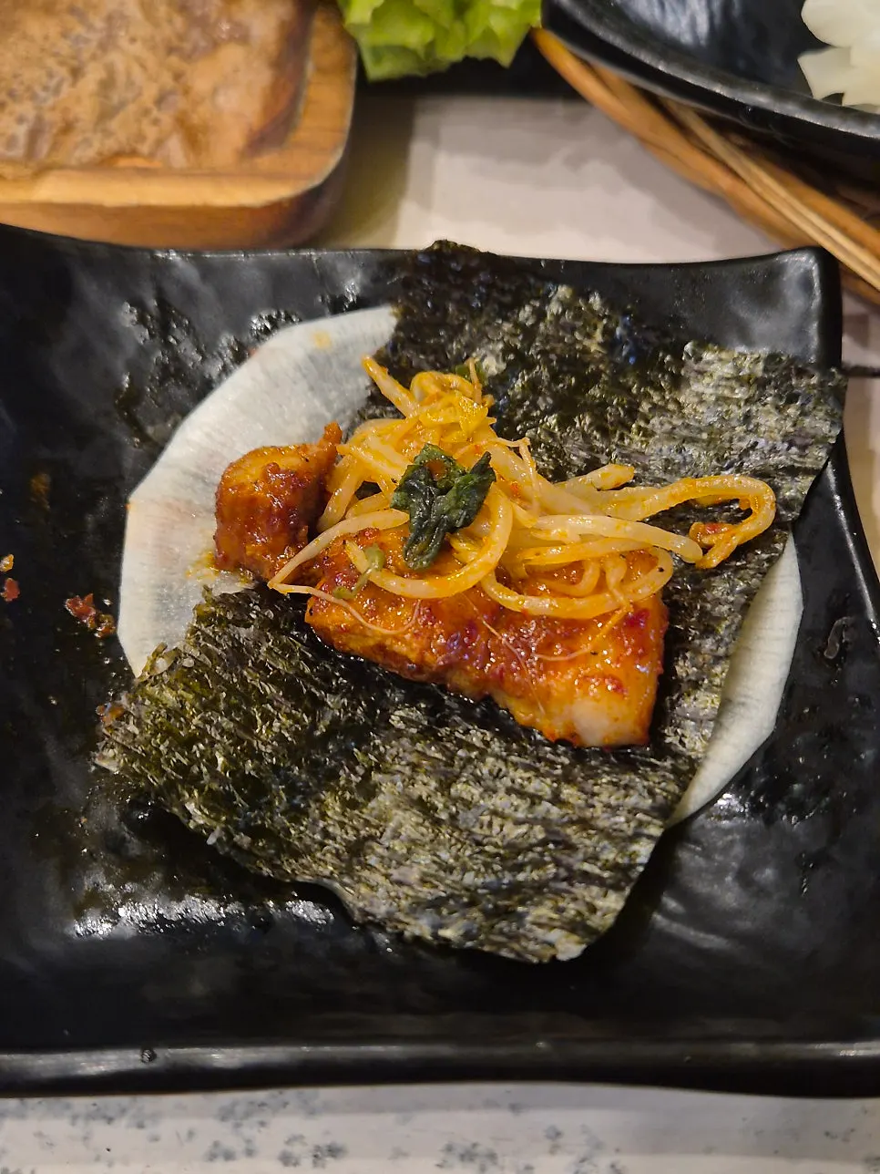 A finished bite of tomato-jang pork belly
