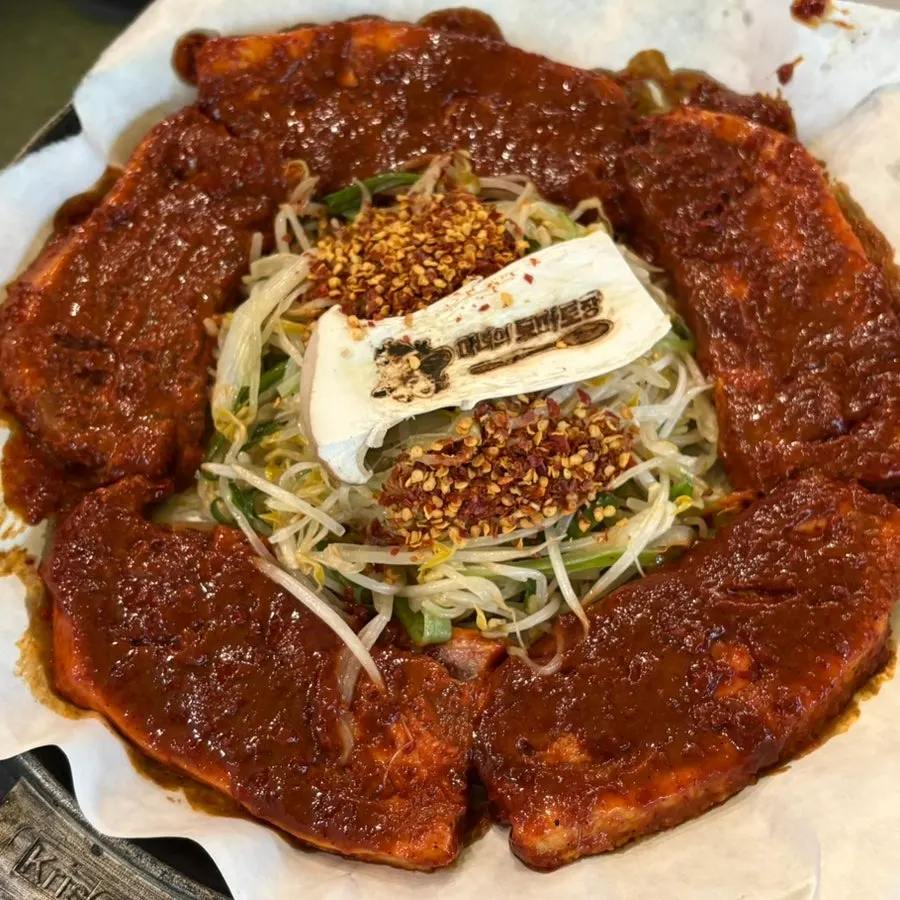 Bright red tomato-jang pork belly and potato pancake