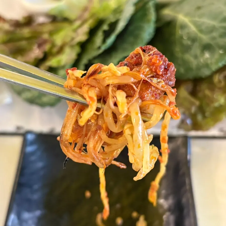 Tomato-jang pork belly placed on a wrap vegetable
