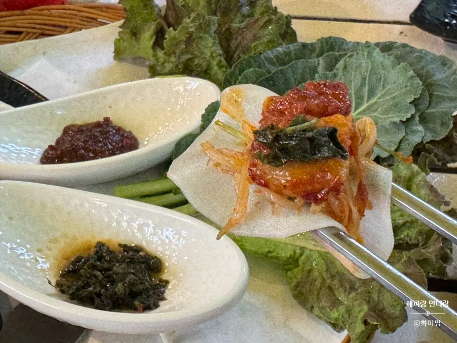 Meat and green onion shreds placed on a crepe