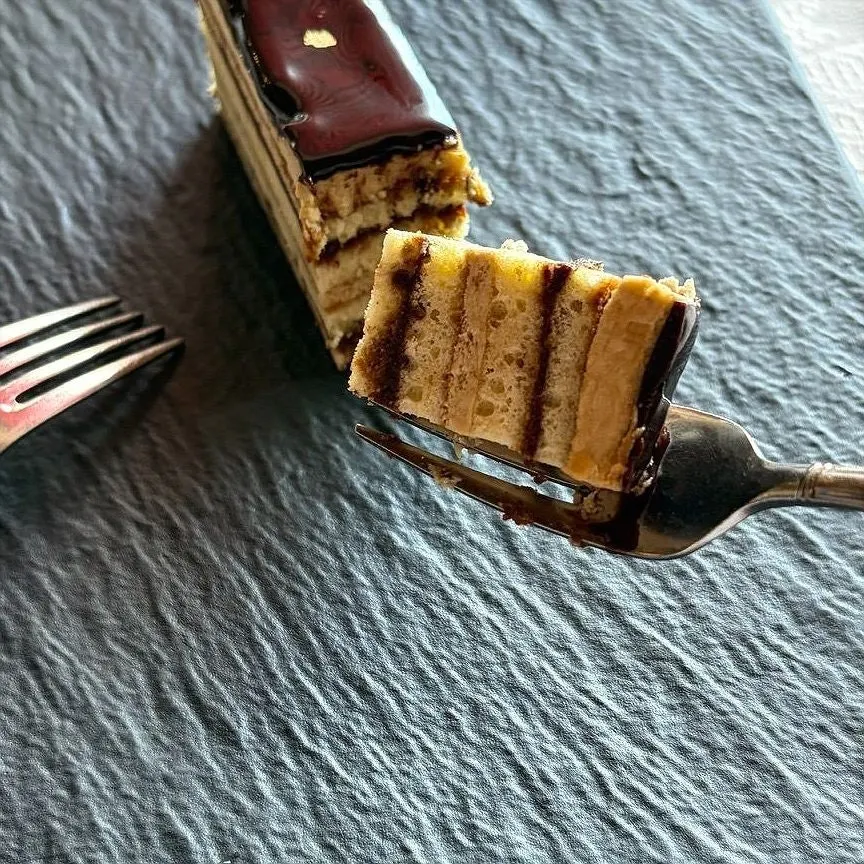 Close-up of opera cake and drip coffee