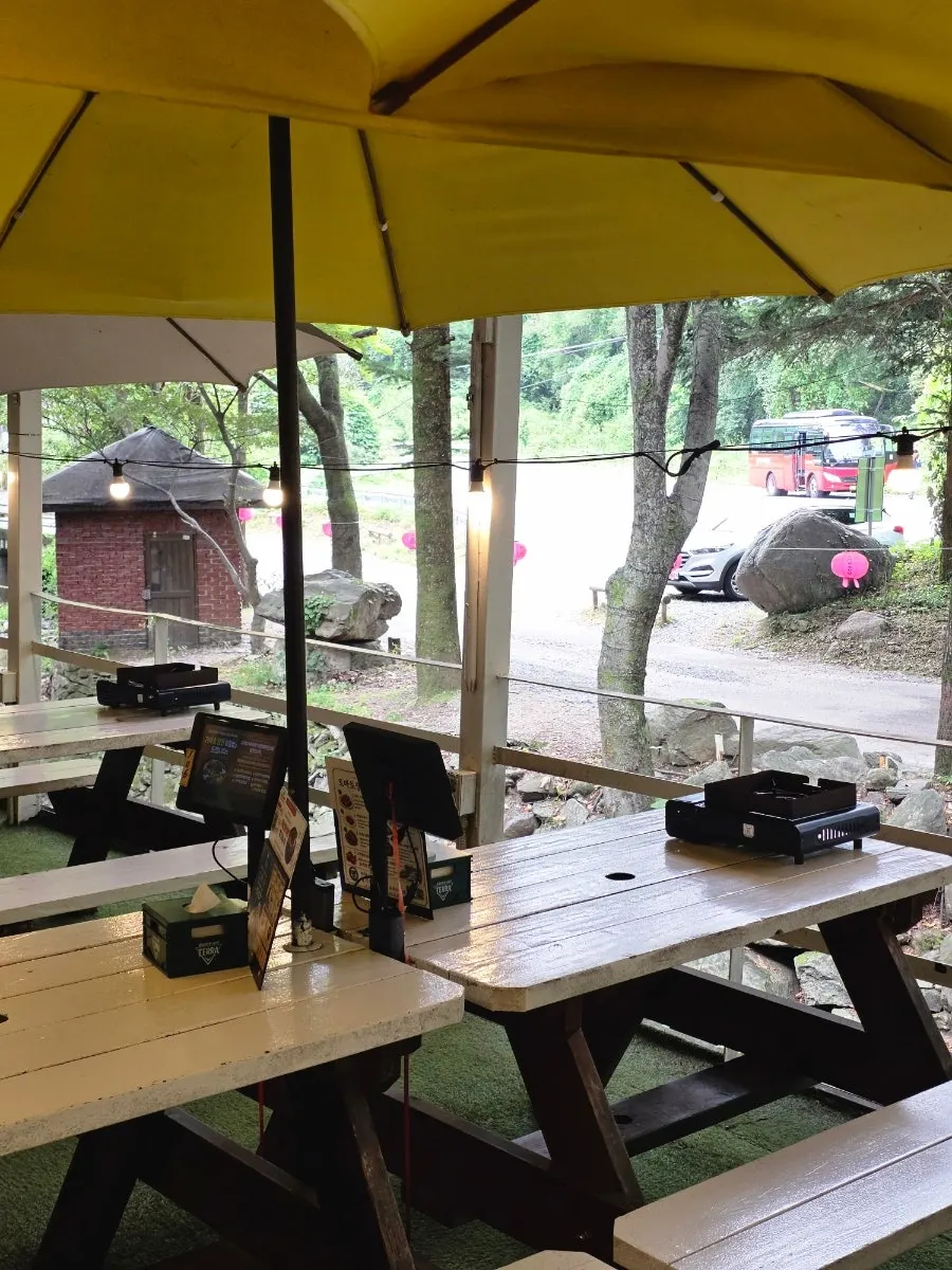 Outdoor tables spread out among the trees