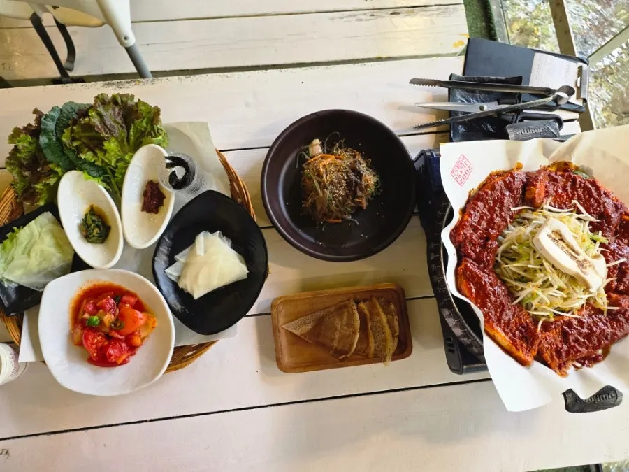 Tomato-jang pork belly set against the creek backdrop