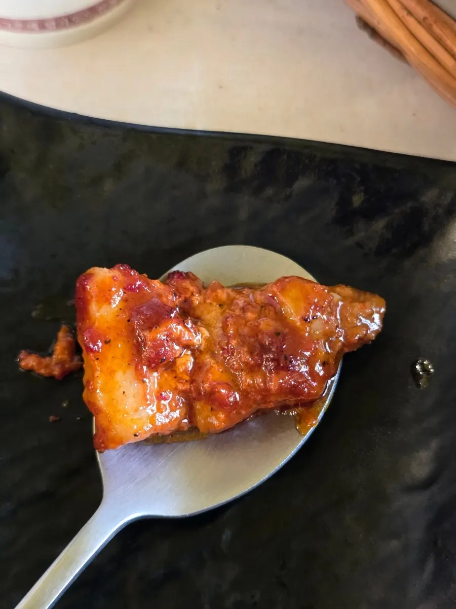 A fully cooked piece of tomato-jang pork belly