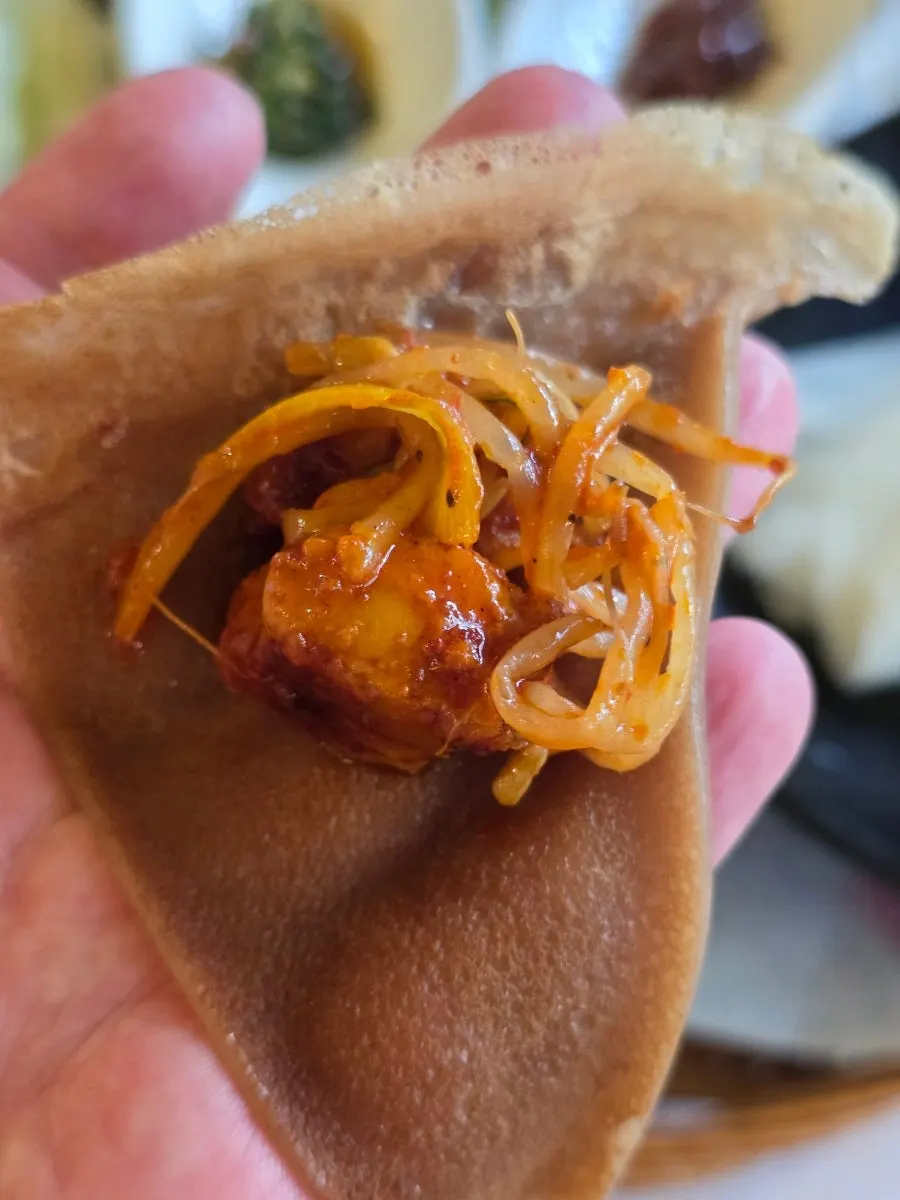 Pork belly served alongside lettuce wraps