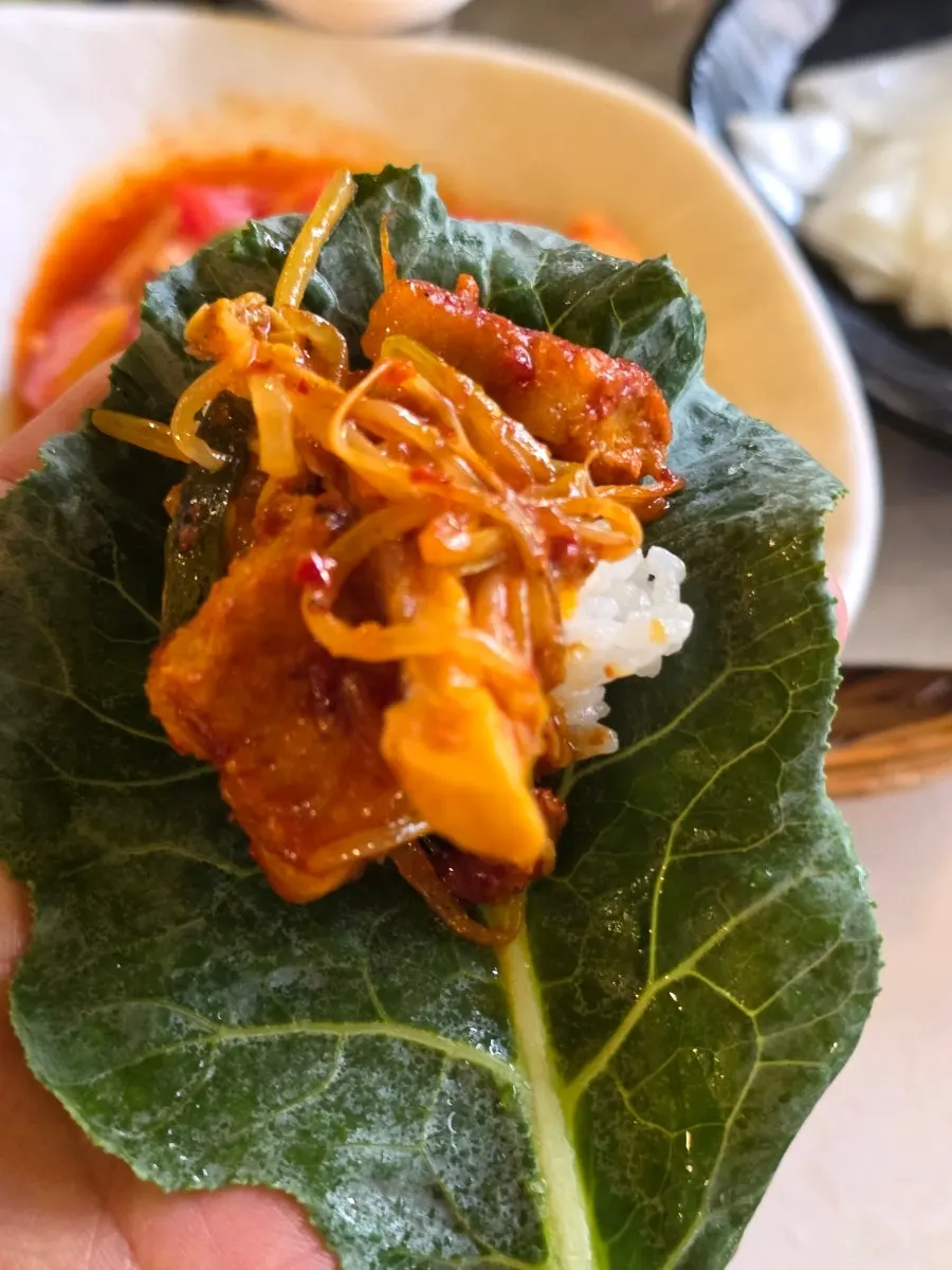 A wrap with pork belly and rice ready to eat
