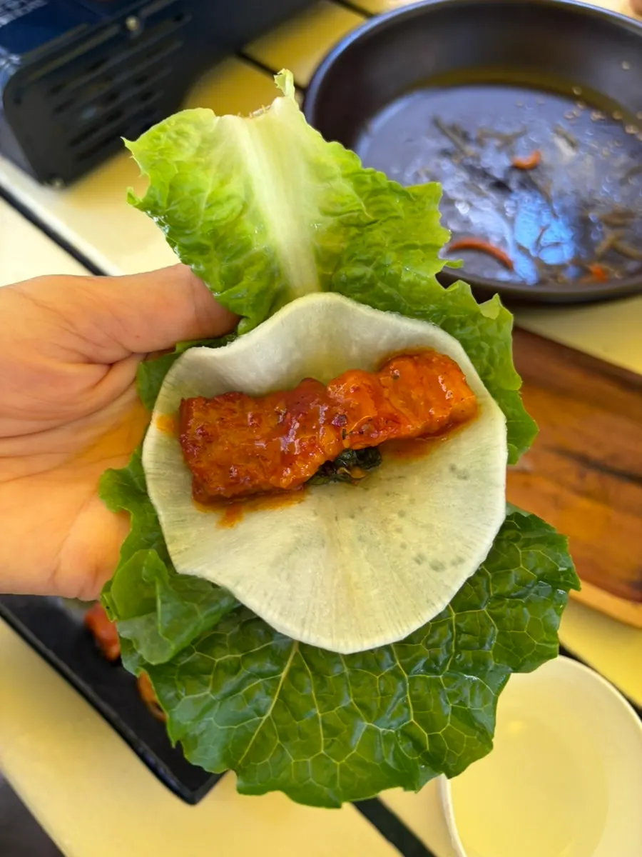 Tomato-jang pork belly wrapped in a rice cracker