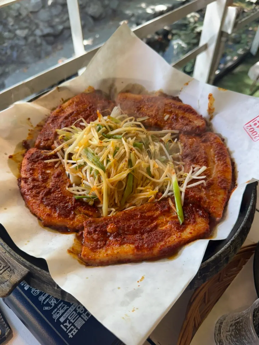 A bowl of tomato-jang kalguksu with chewy noodles