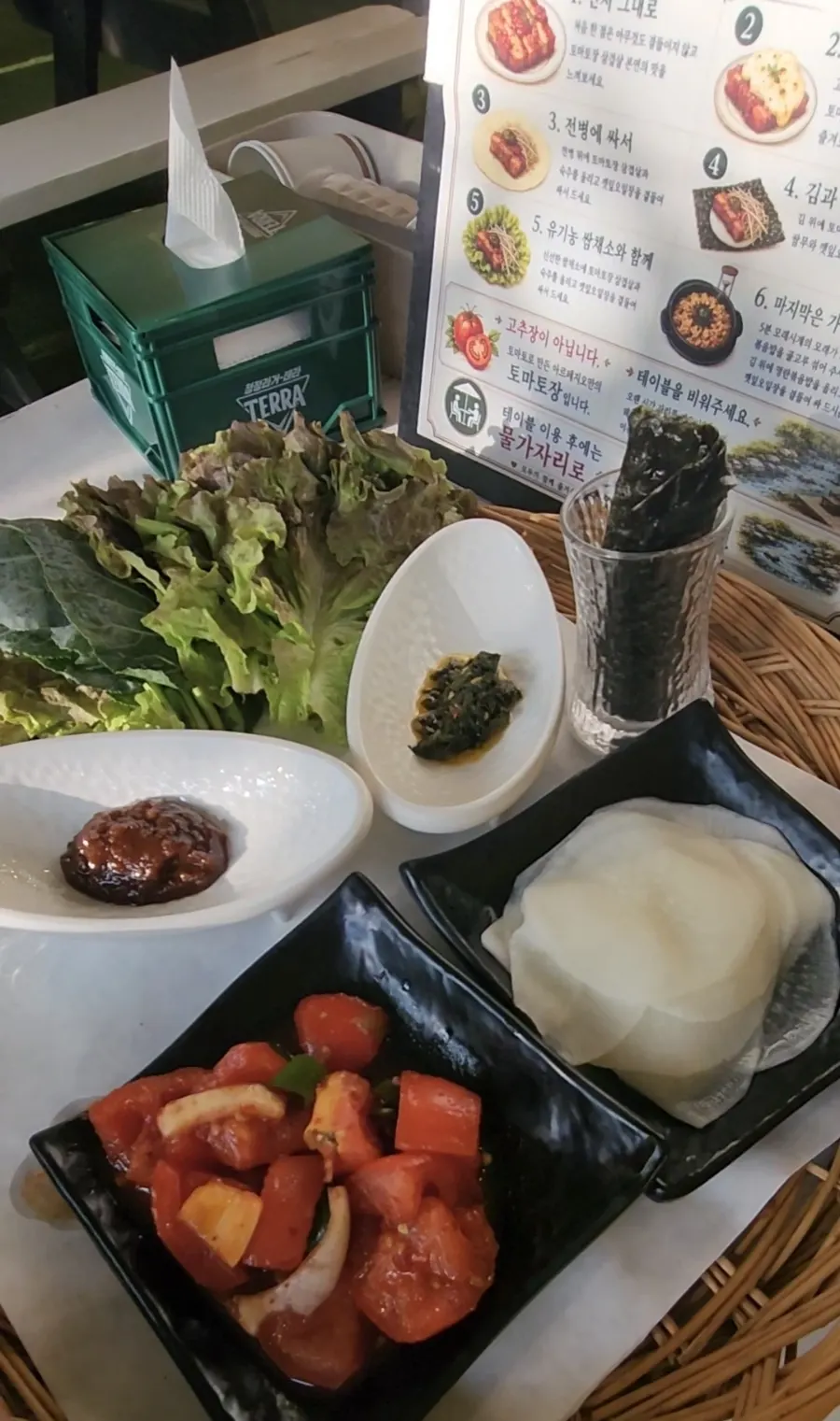 A plate of tomato-jang pork belly topped with cheese