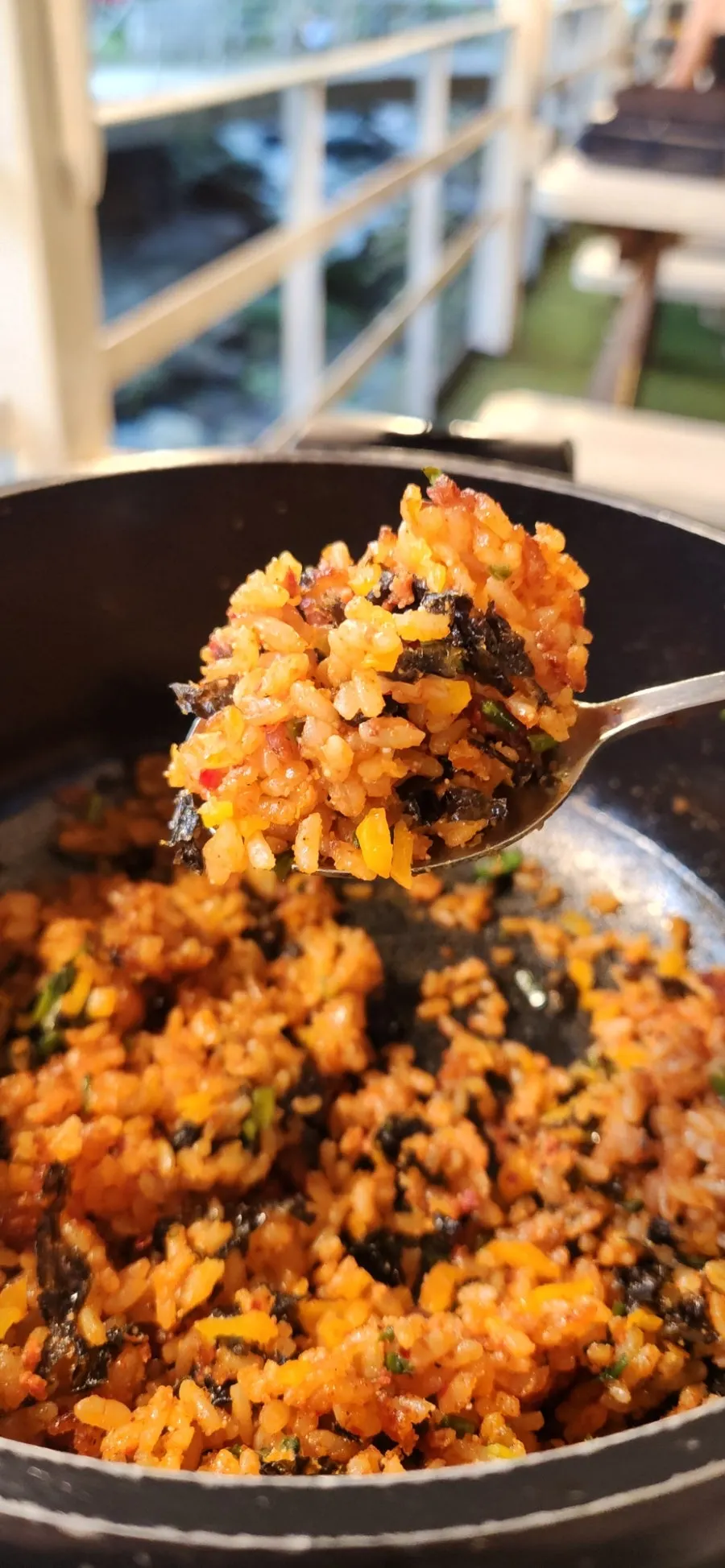 Scraping up the crispy rice from the bottom of the stone pot