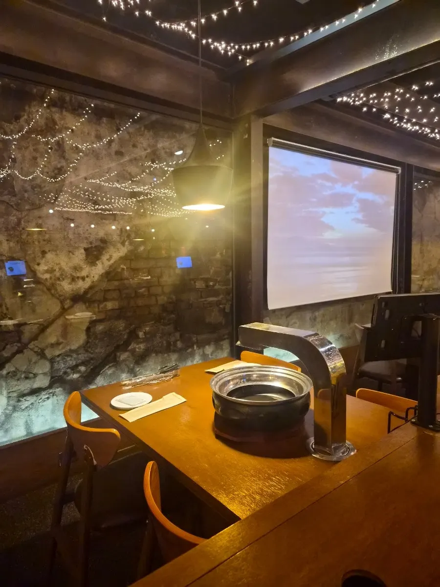 Table with a charcoal grill and ventilation system