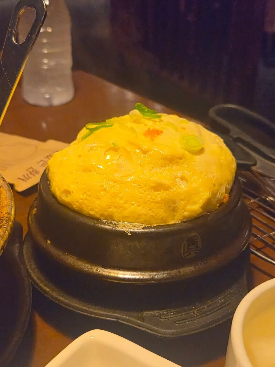 Puffed steamed egg in an earthenware bowl
