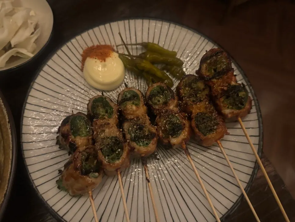 Pork belly-scallion skewers grilled and rolled with pork belly