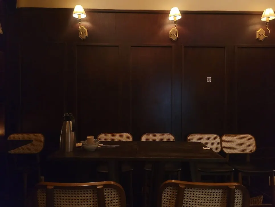 Long bar seating with brown leather chairs