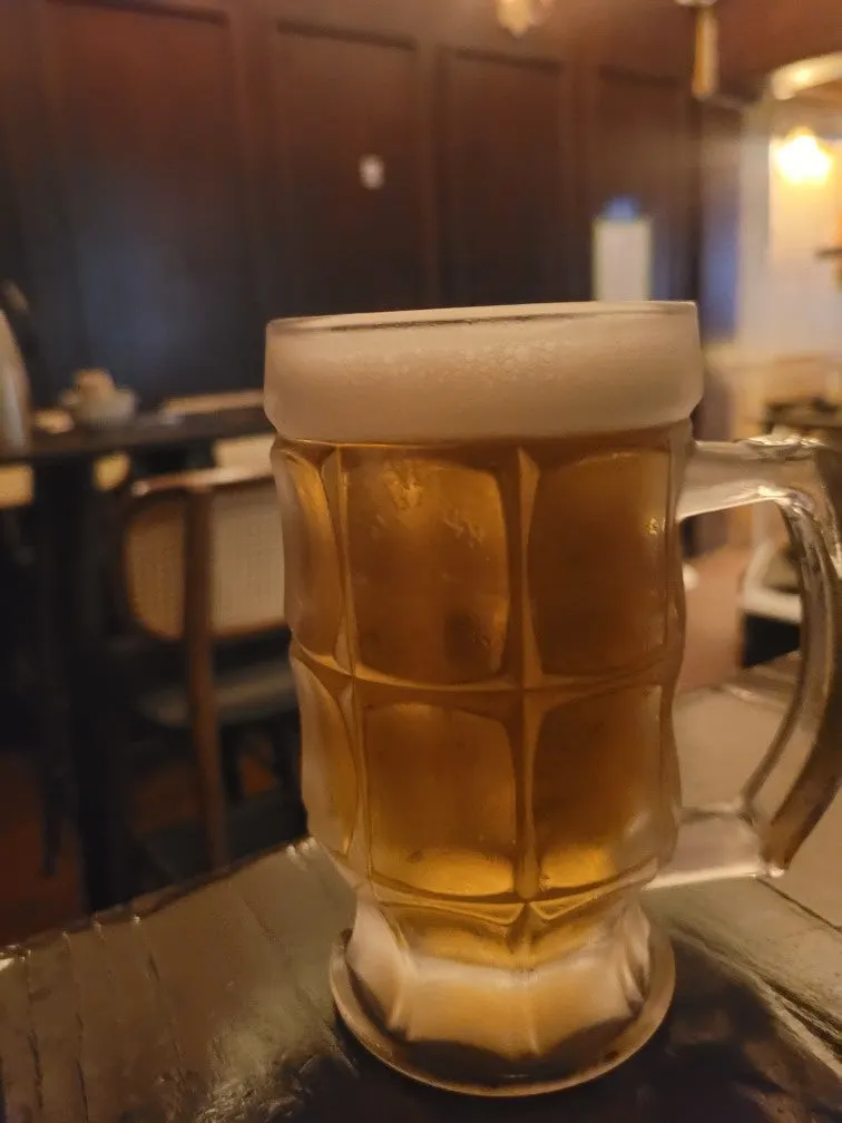 Asahi draft beer glass with layered foam