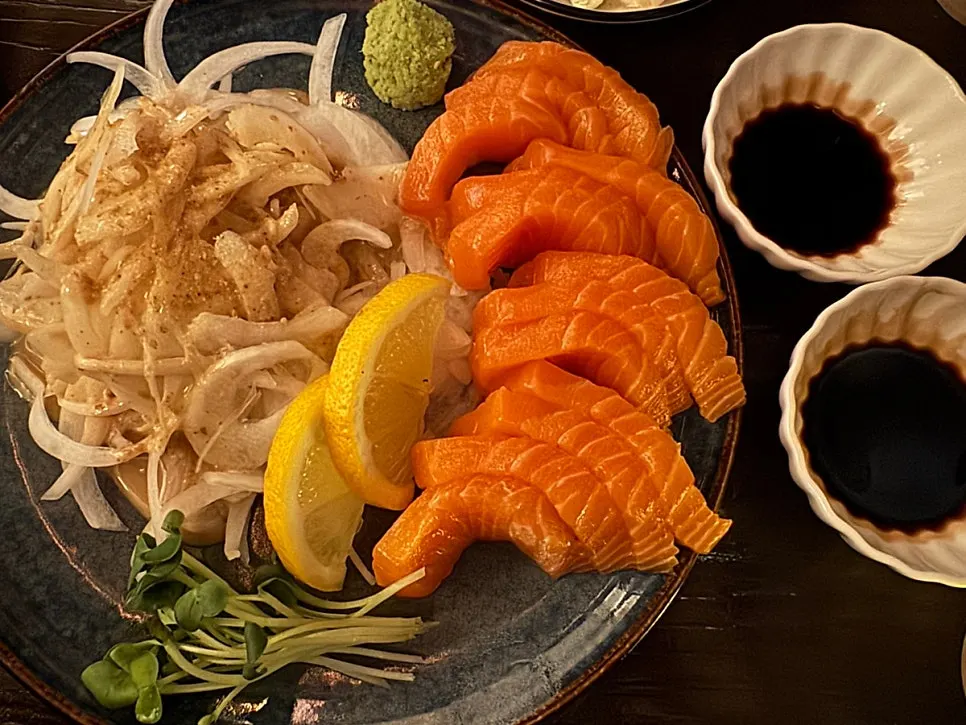 Thickly sliced salmon sashimi with an individual soy sauce dish