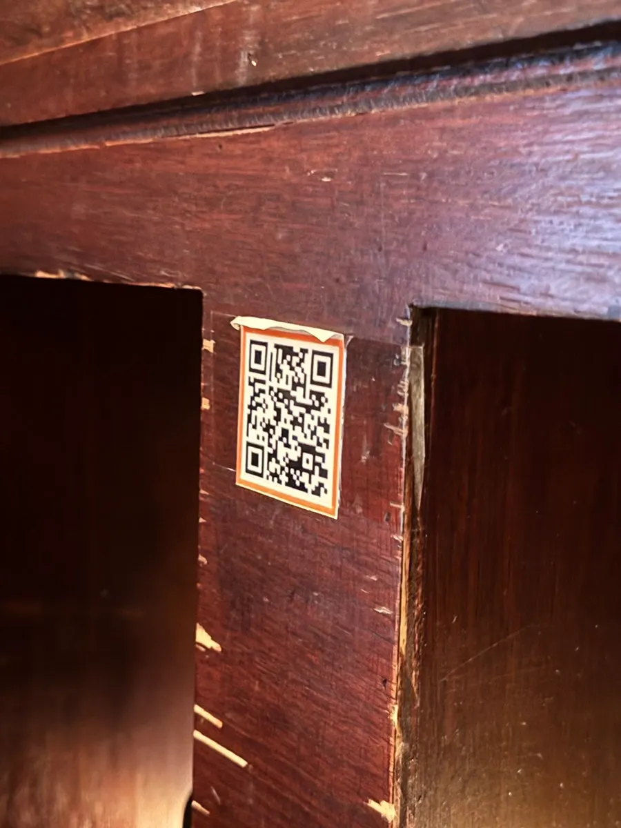 Wi-Fi QR code and call bell next to the table
