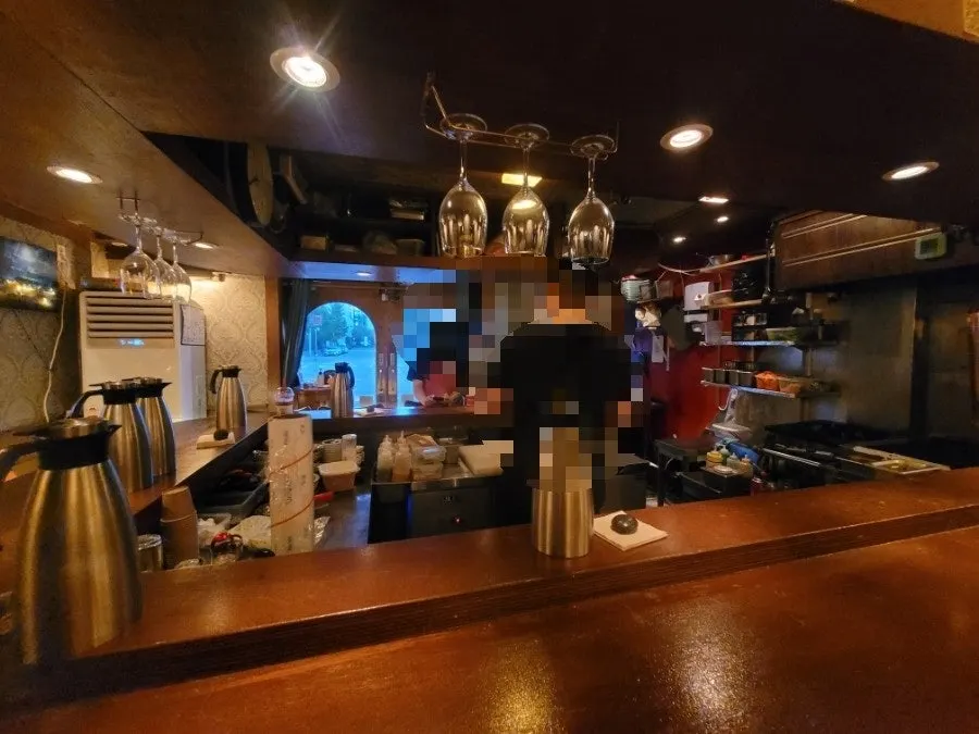 Izakaya entrance with a wooden door and vintage wall interior