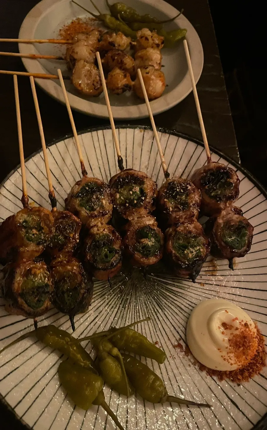 Close-up of pork belly and scallion skewer