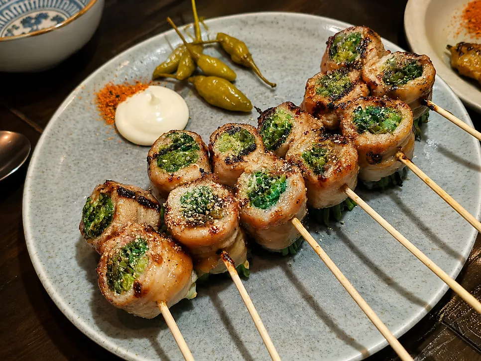 Pork belly scallion skewers and beef intestine skewers together on the table