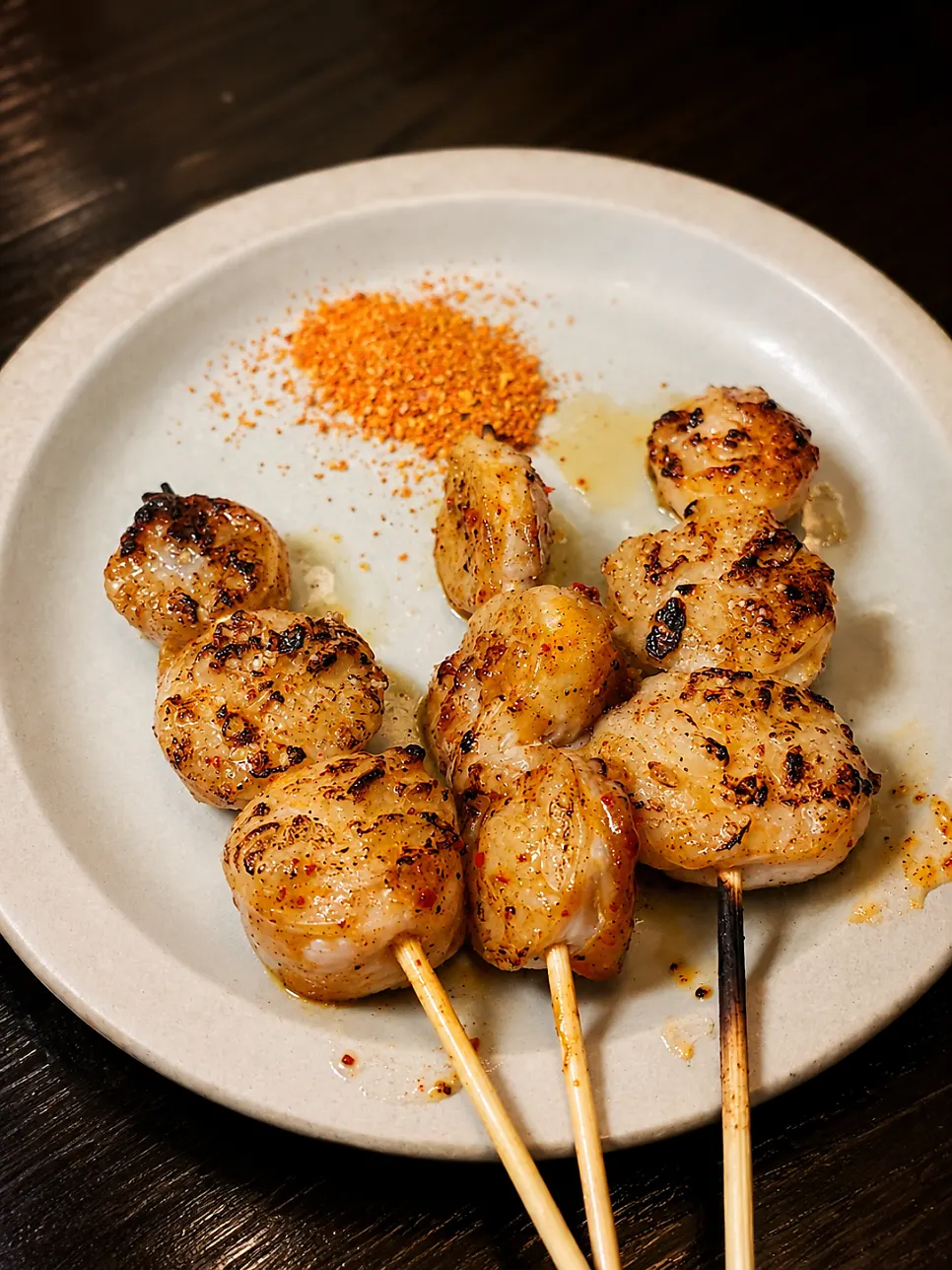 Pork belly scallion skewers and beef intestine skewers arranged vertically