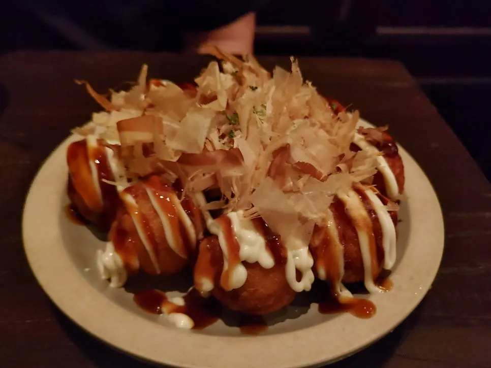 Takoyaki topped with a generous amount of bonito flakes